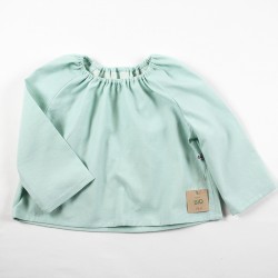 Une idée de cadeau de naissance pour ce haut simple et pratique d'un beau pastel façon layette nature